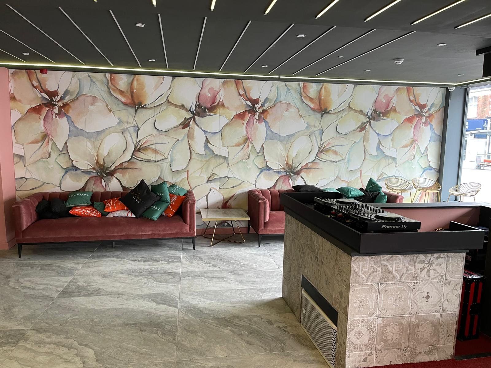 Bar lounge seating with floral feature wall