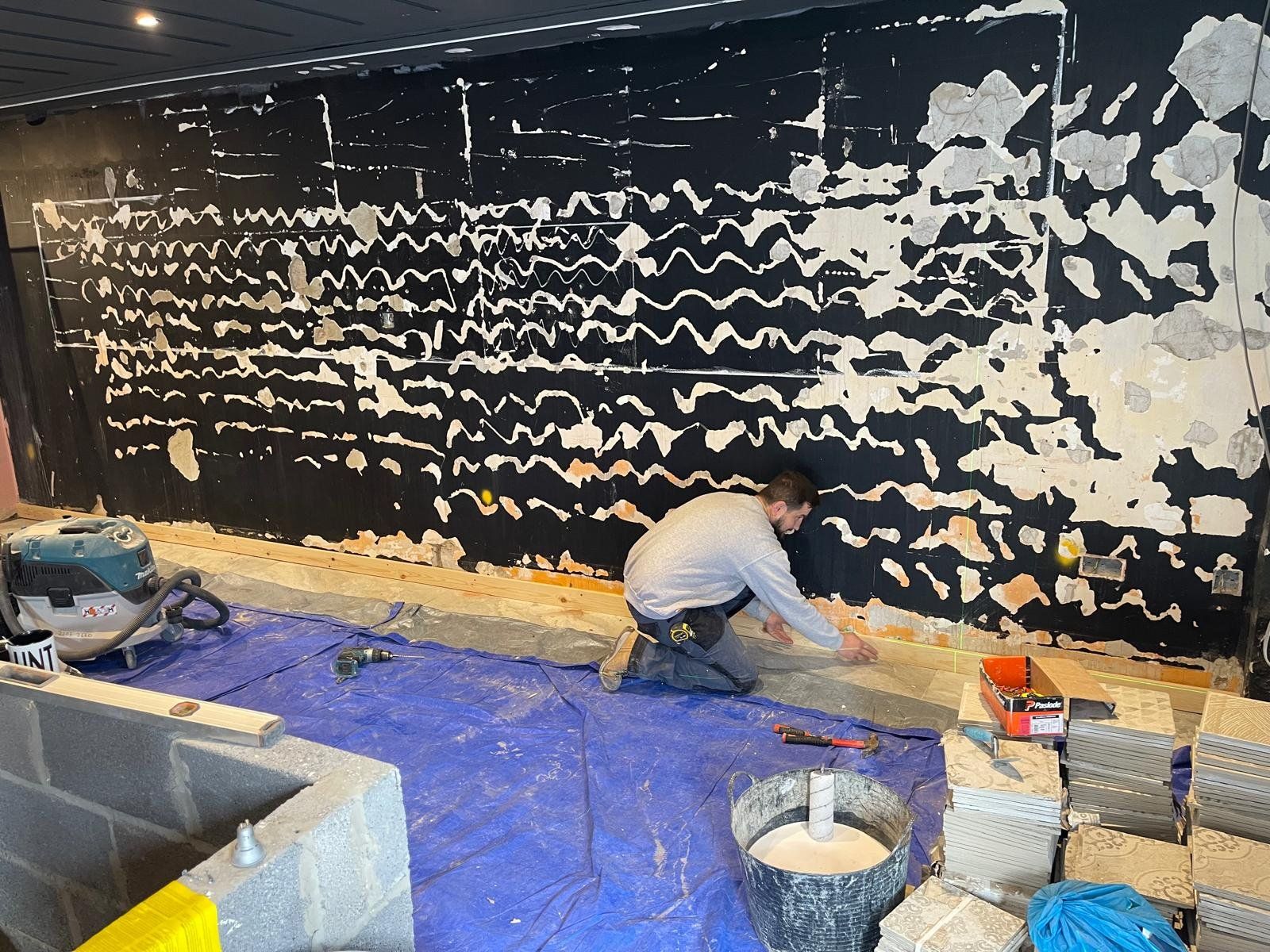 Feature wall prepared with waterproof plaster during a bar fit-out
