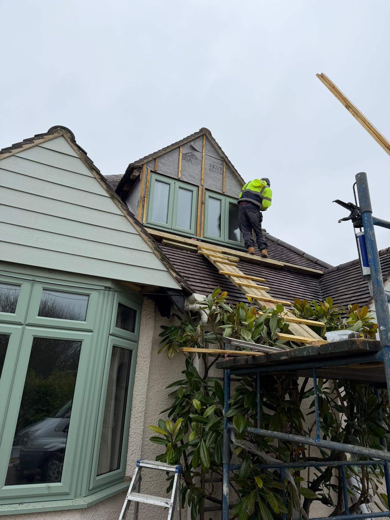 Builder working at a dormer roof