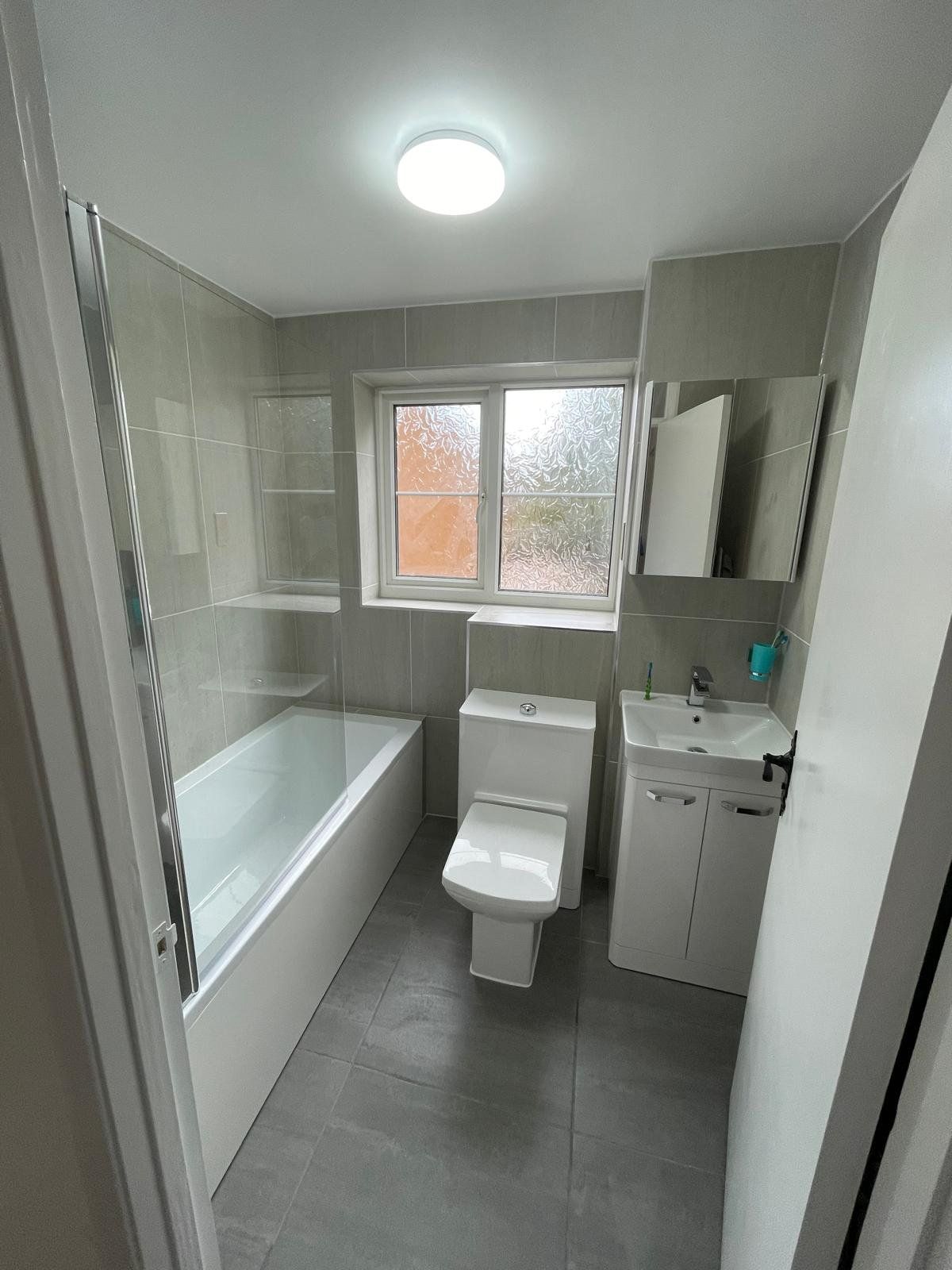 Family bathroom renovation in grey tile