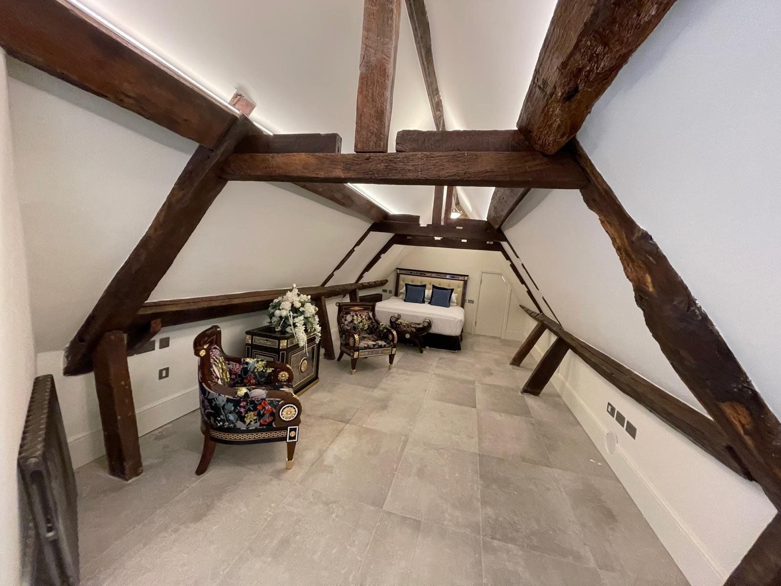 Finished loft conversion with exposed beams