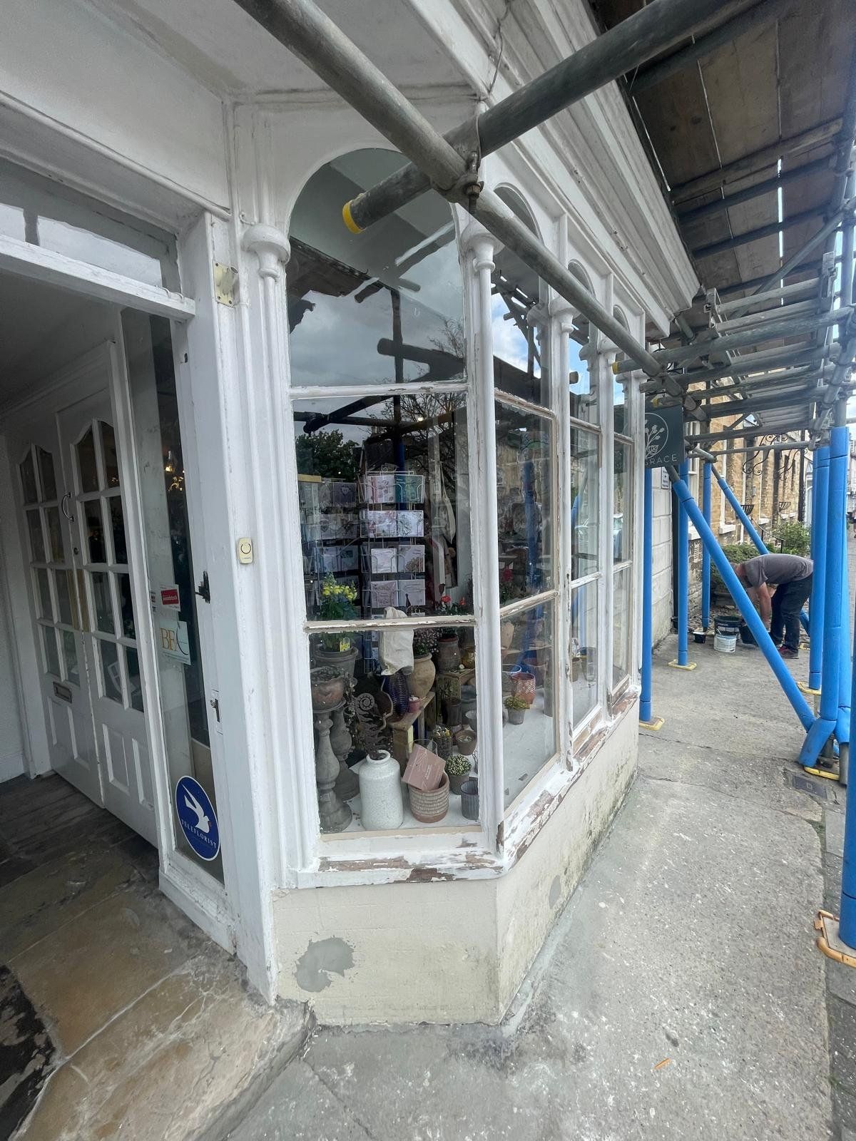 Historic shopfront under scaffold during restoration