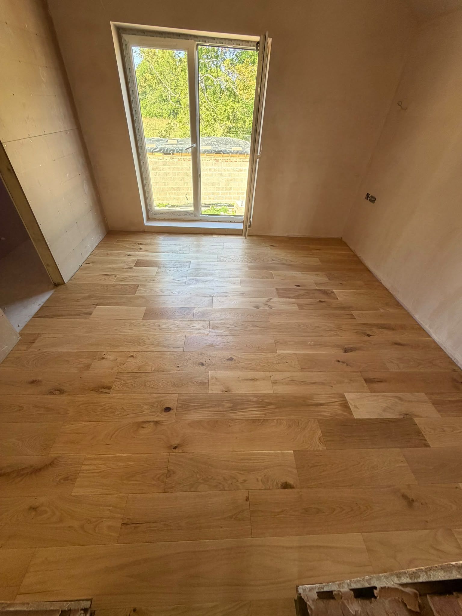Oak flooring laid in a renovated room