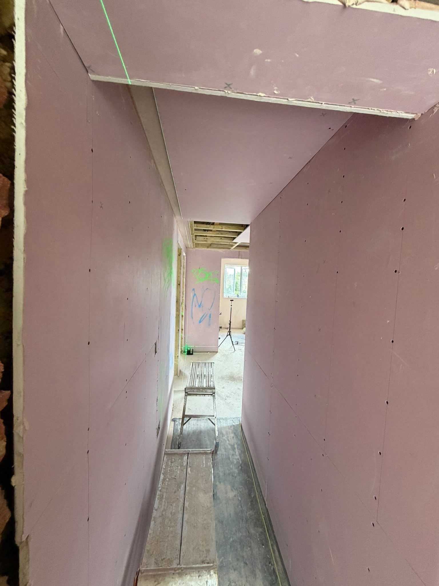 Plasterboard lining in a corridor before finishing
