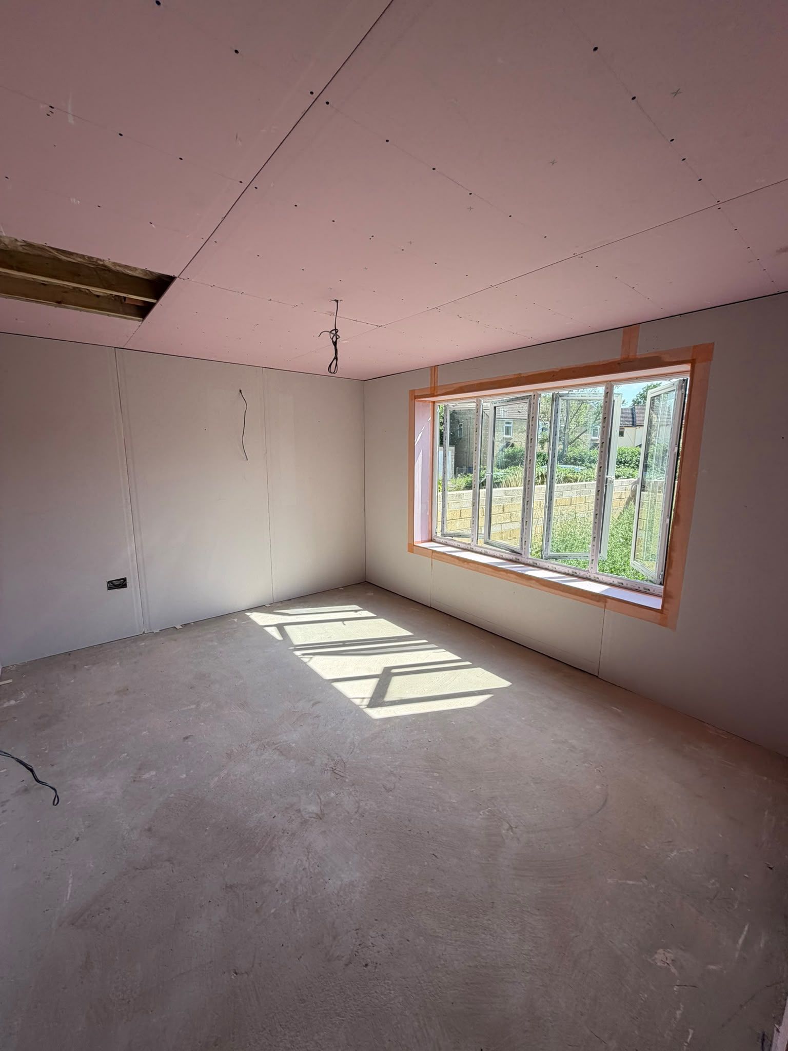 Plasterboard walls and ceiling in a room under renovation