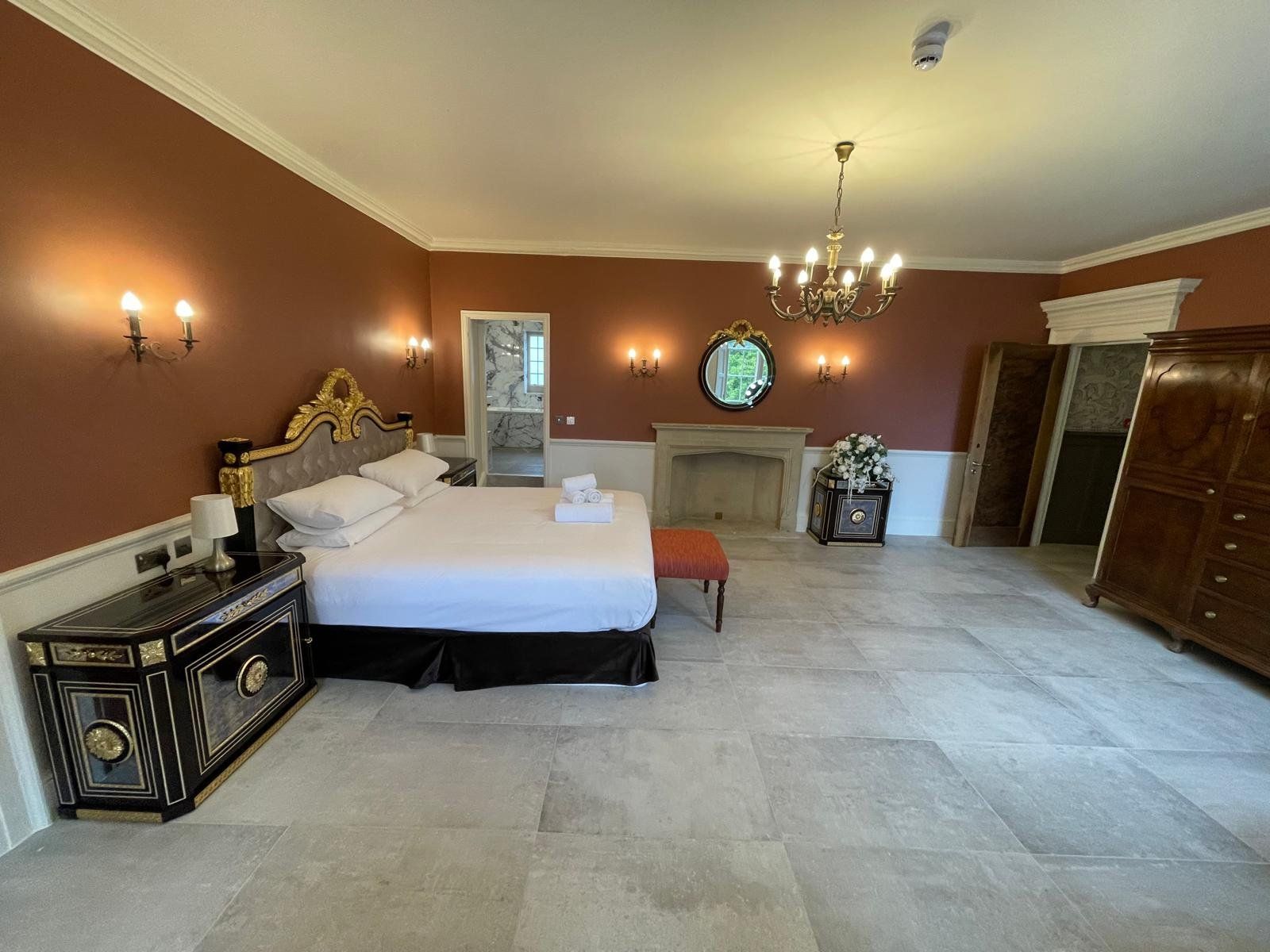 Bedroom with restored stone fireplace