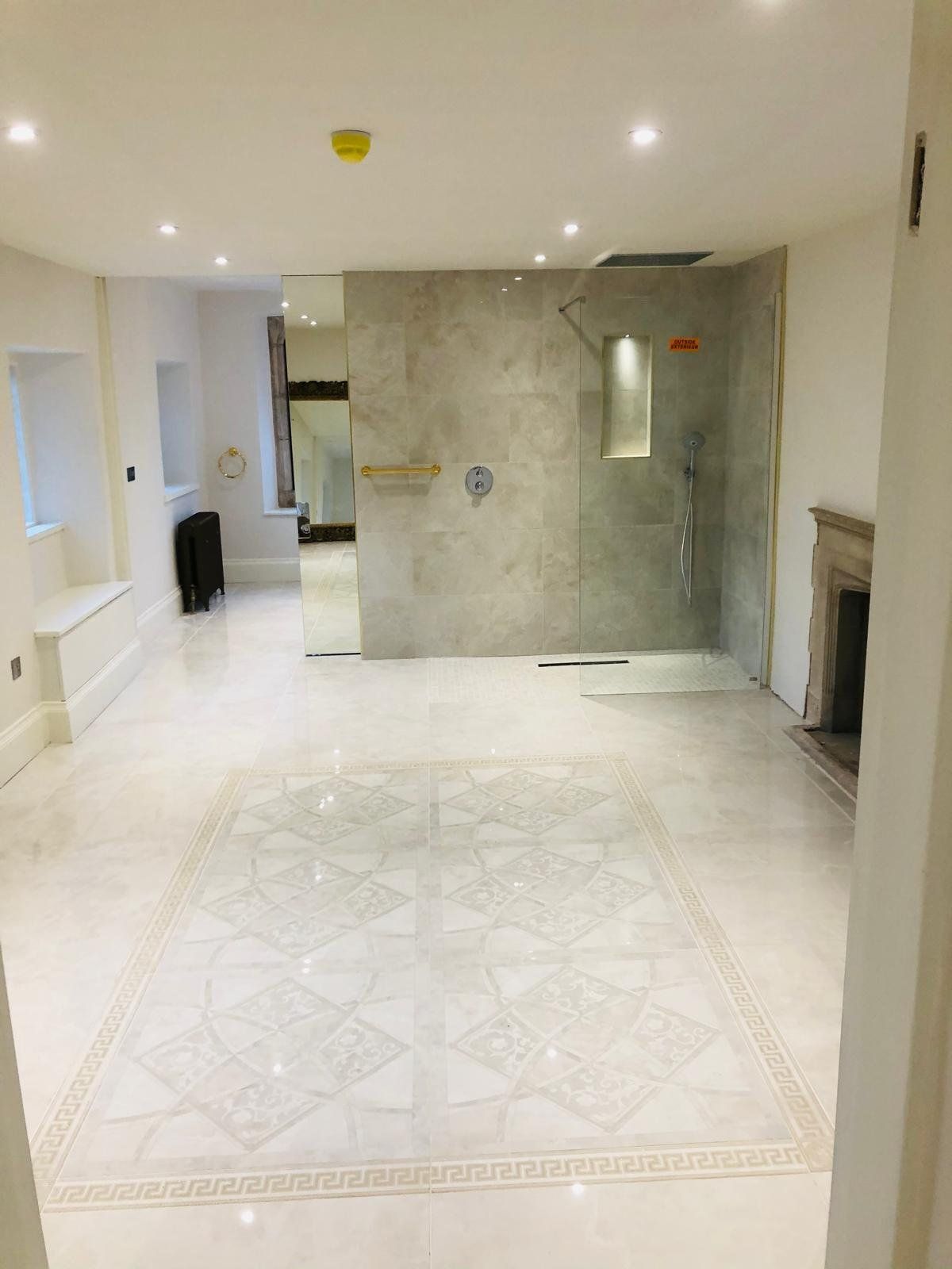 Walk-in shower on a marble floor