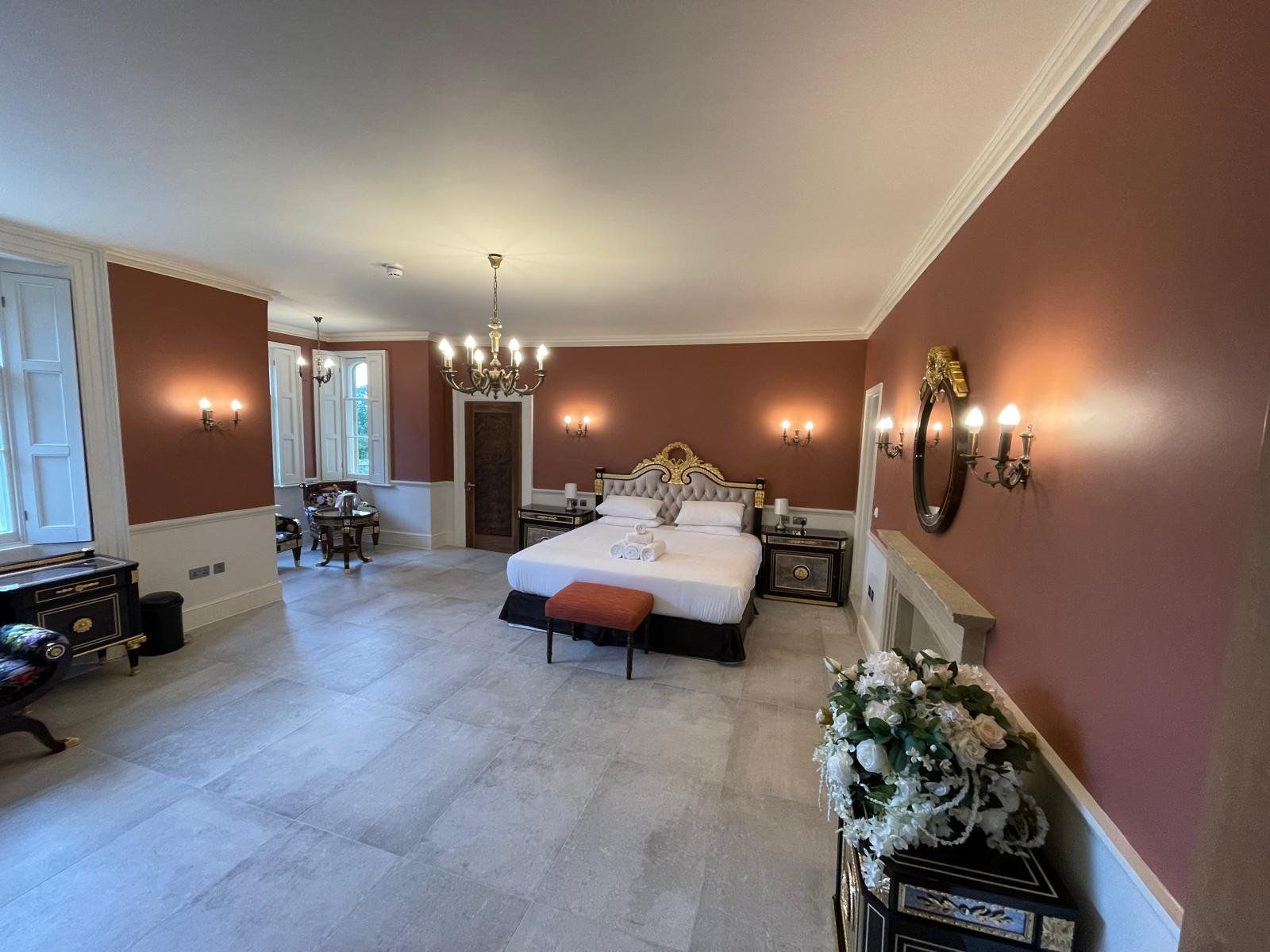 Period bedroom decorated in dark red