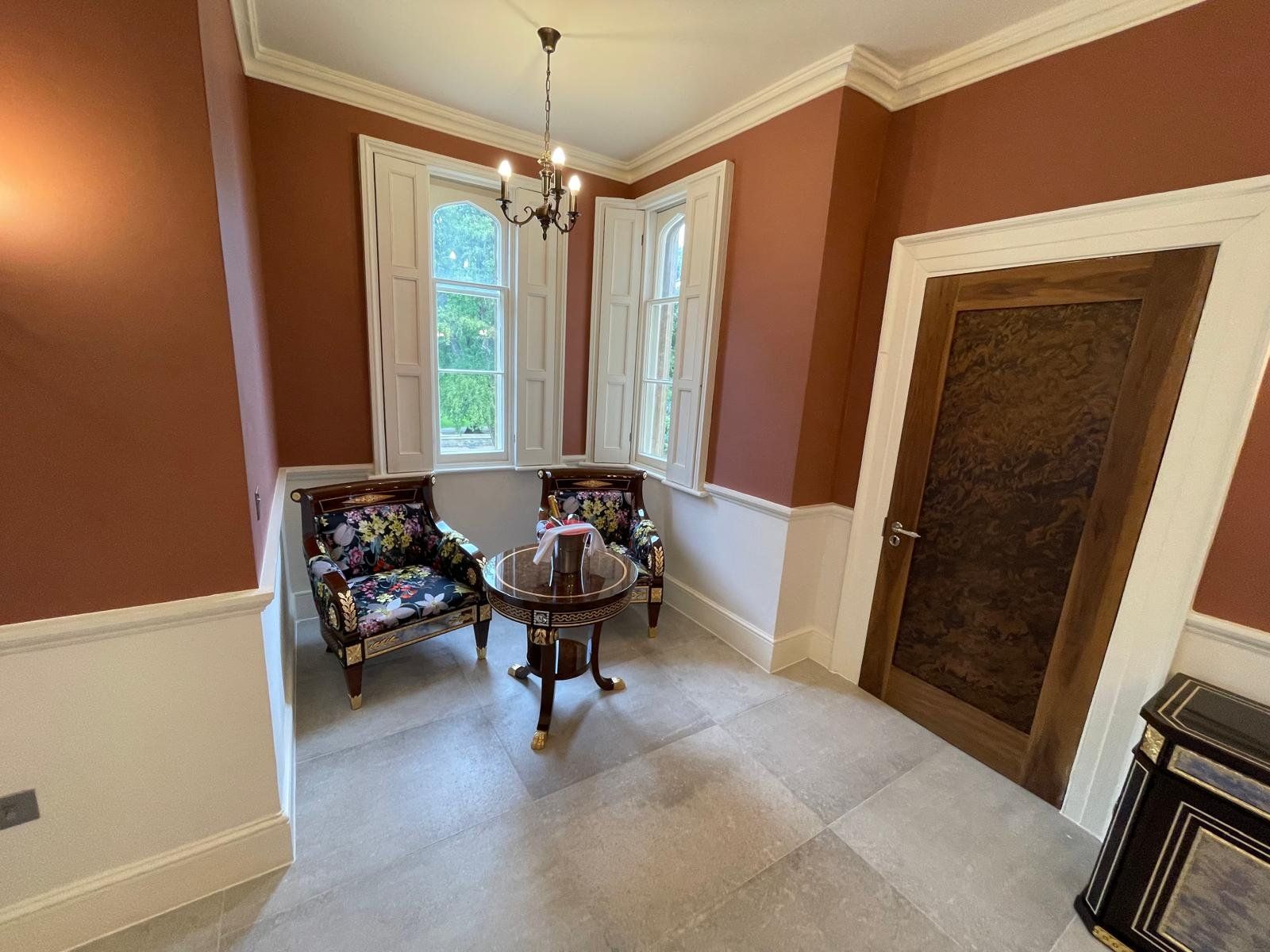 Period sitting room refurbished with deep red walls