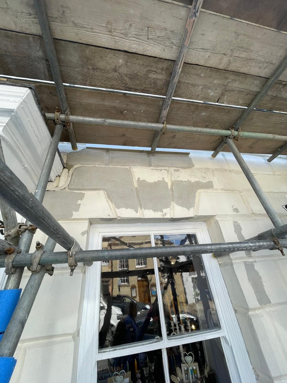 Stone repair in progress on a shopfront