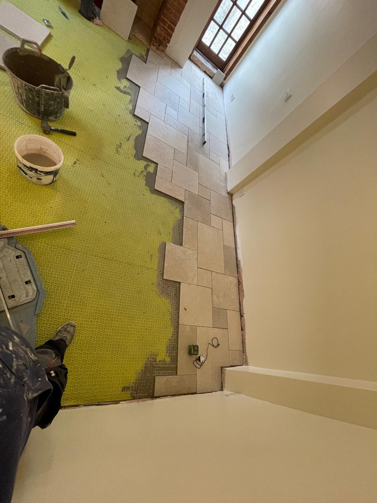 Stone floor tiles being laid in a period property