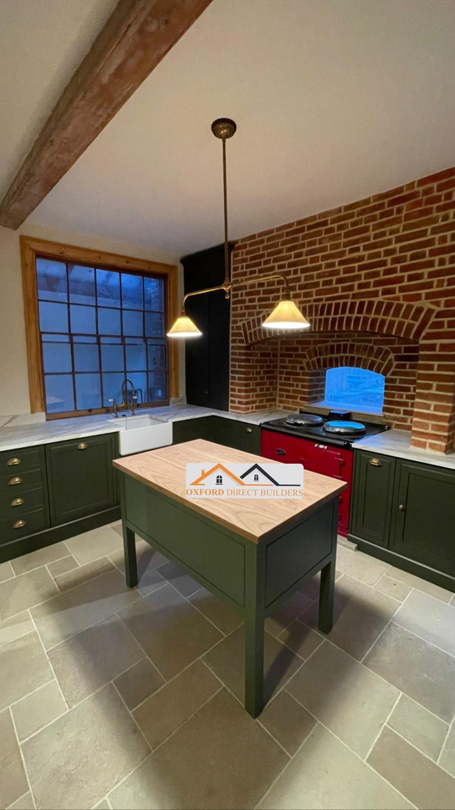 Bespoke dark green shaker kitchen with brick arch oven installed by Oxford Direct Builders in Oxfordshire