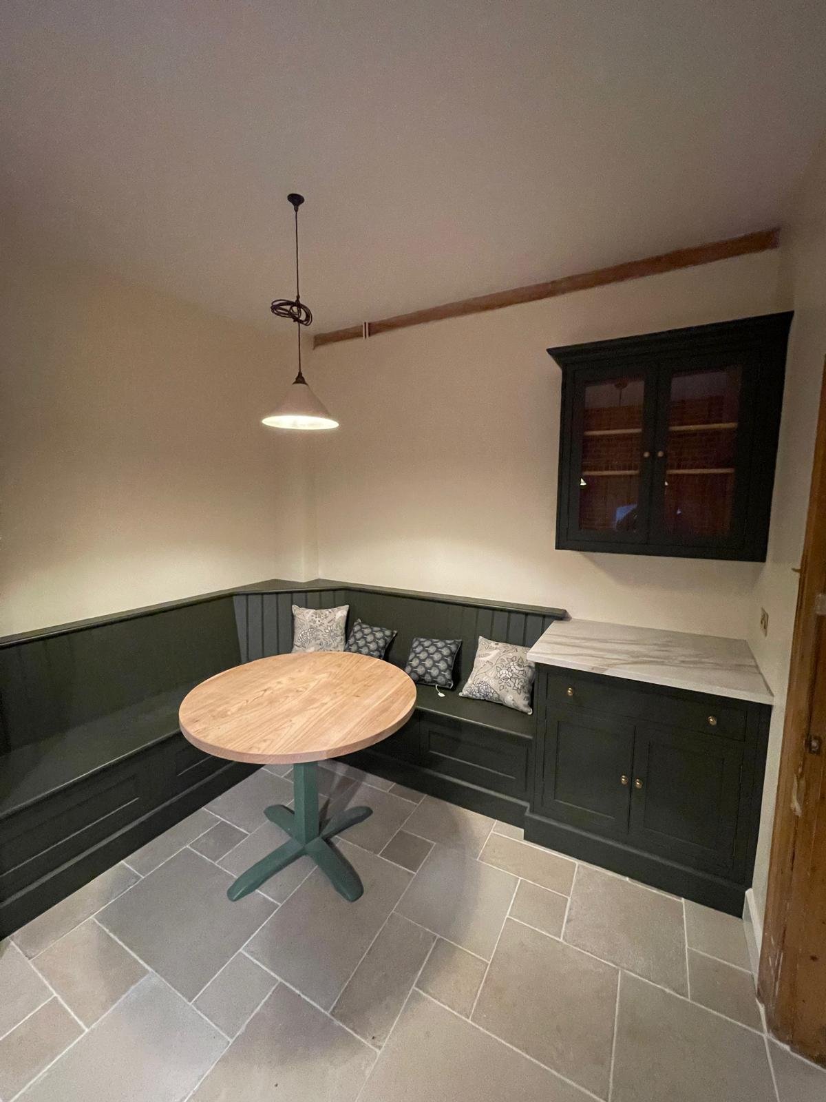 Kitchen breakfast nook with green cabinetry and marble worktop in Oxford